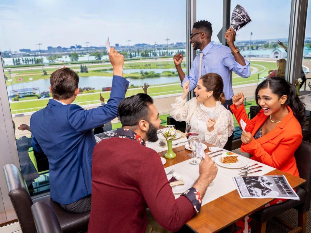 People enjoying a horse race at an office holiday party