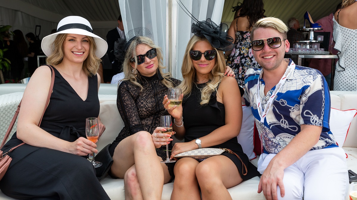 Four guests enjoying an outdoor event at Woodbine Racetrack